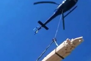 Helikopter løfter hyttematerialer i lasteline